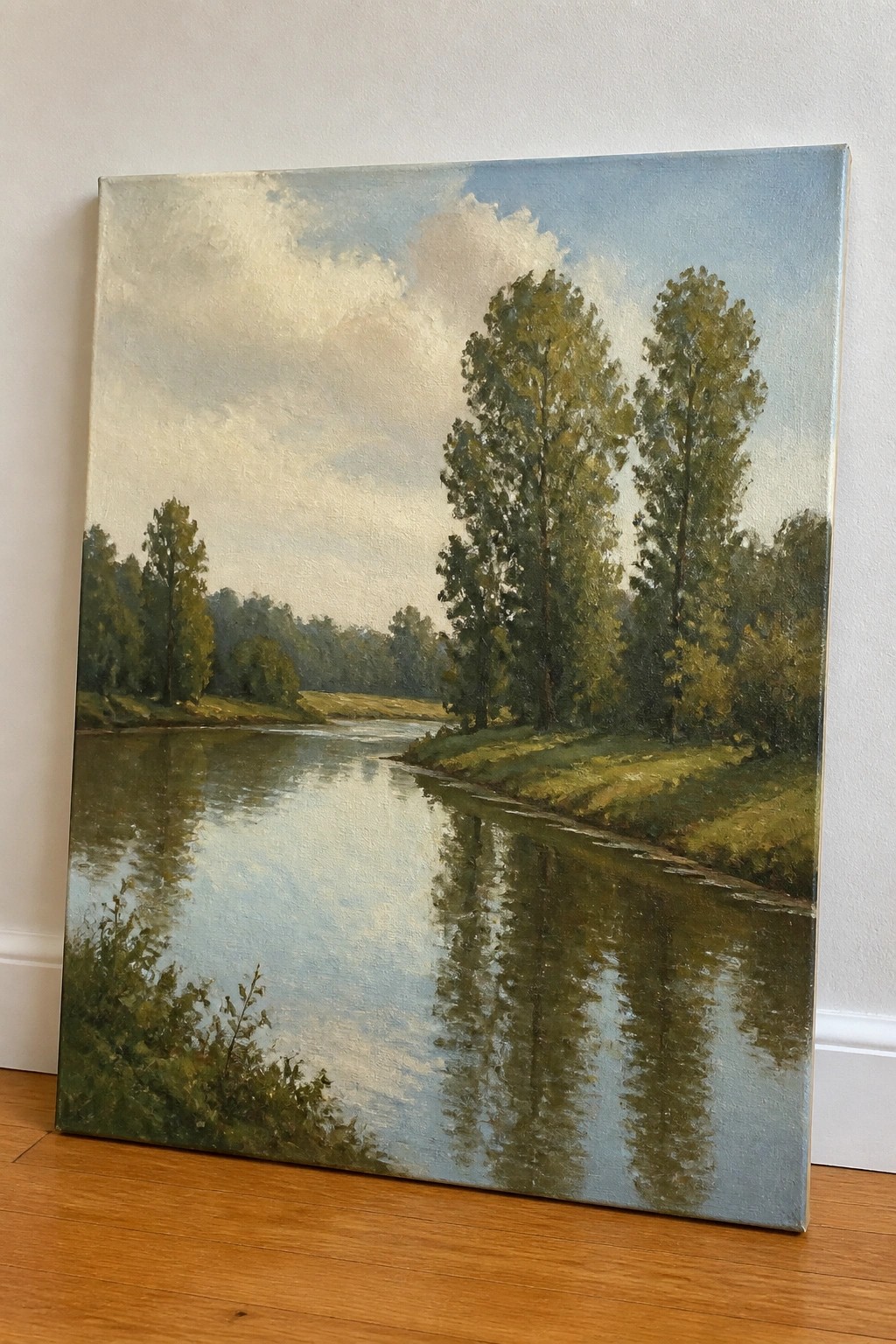 Oil painting of a calm river with tall trees reflecting under a cloudy blue sky