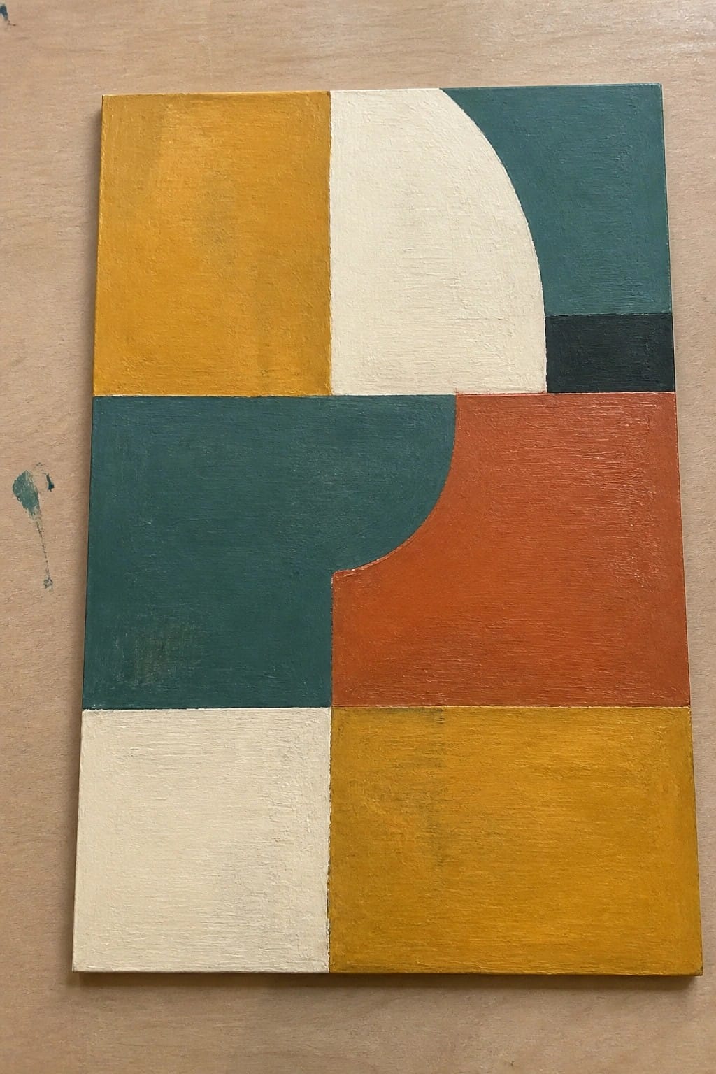 Abstract geometric painting with curved white shape amid yellow, teal, orange blocks.