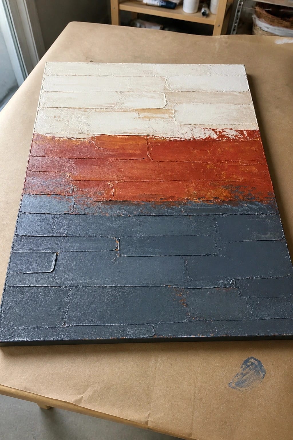 Abstract painting with horizontal bands of white, orange-red, and dark gray on canvas