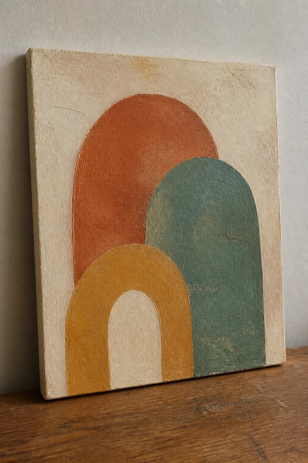 Abstract painting with overlapping arches in orange, teal, yellow, and white.