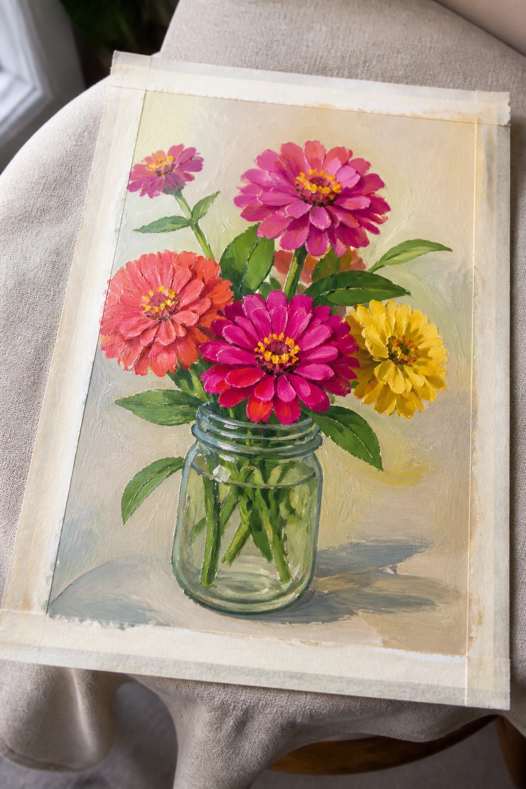 Vibrant painting of pink, red, and yellow zinnias in a glass mason jar.