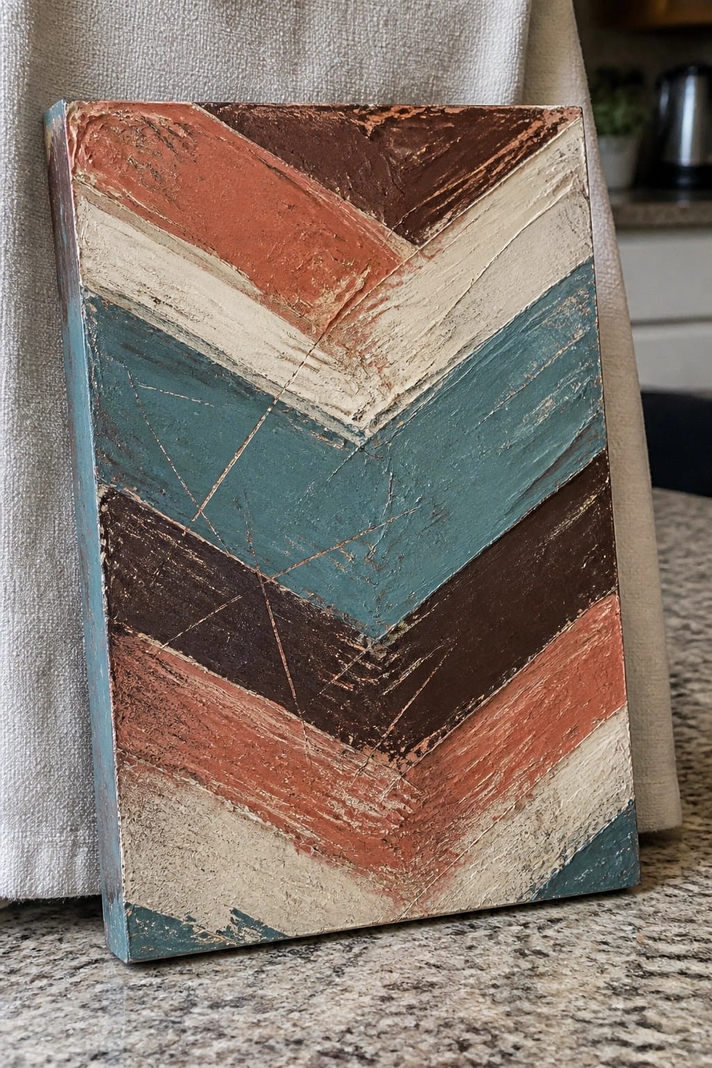 Distressed chevron painting in teal, rust, brown, and cream on canvas