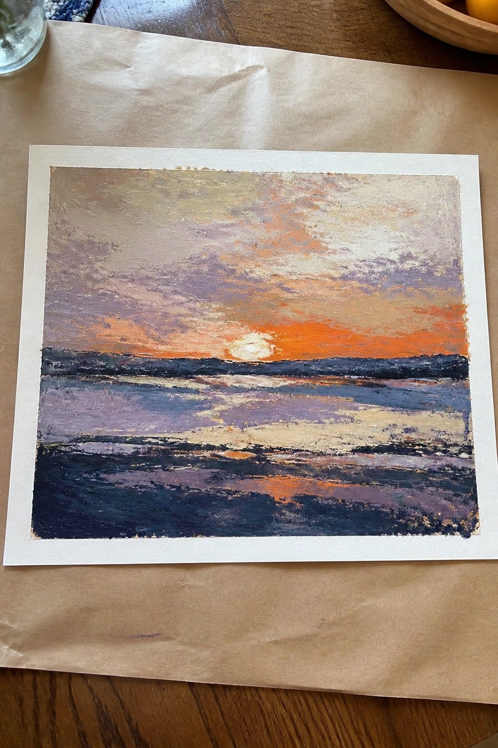 Impressionistic painting of orange sunset over dark blue ocean with purple sky