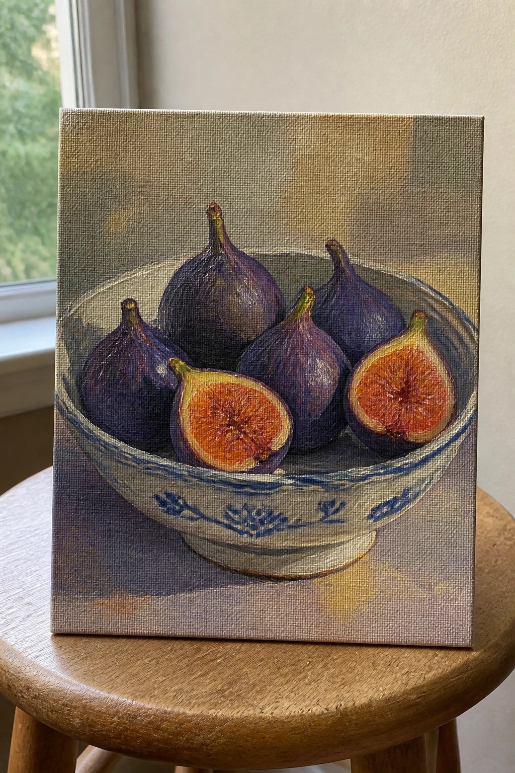 Realistic painting of purple figs in blue-patterned bowl, two halved, on wooden stool
