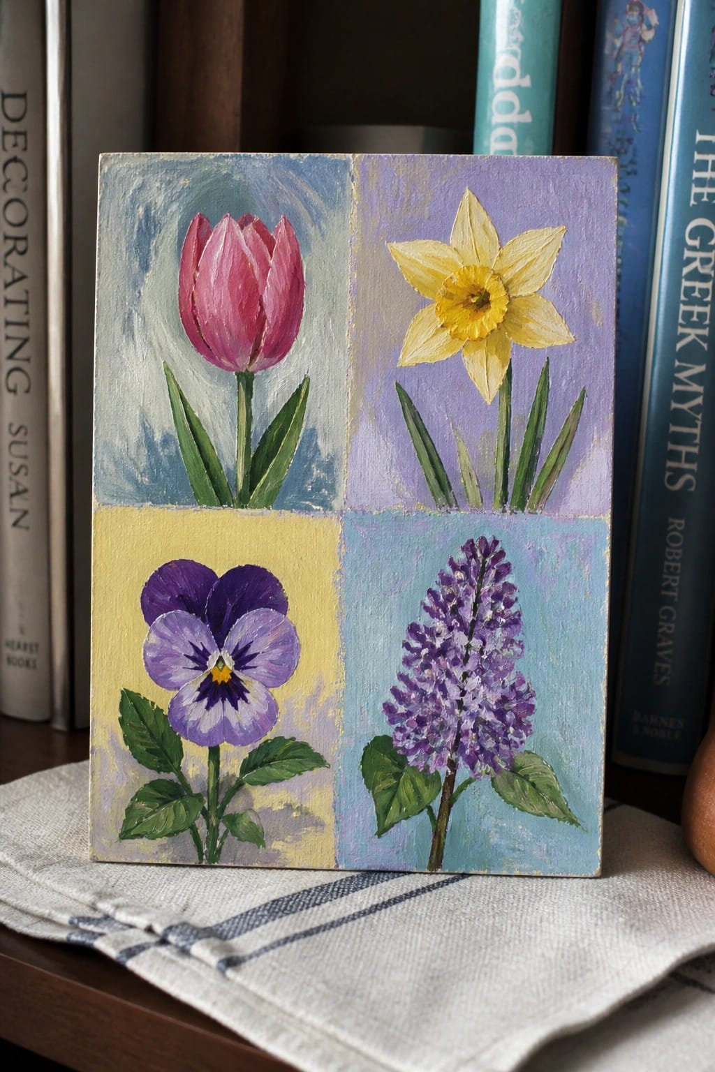 Four-quadrant painting of pink tulip, yellow daffodil, purple pansy, and lilac.