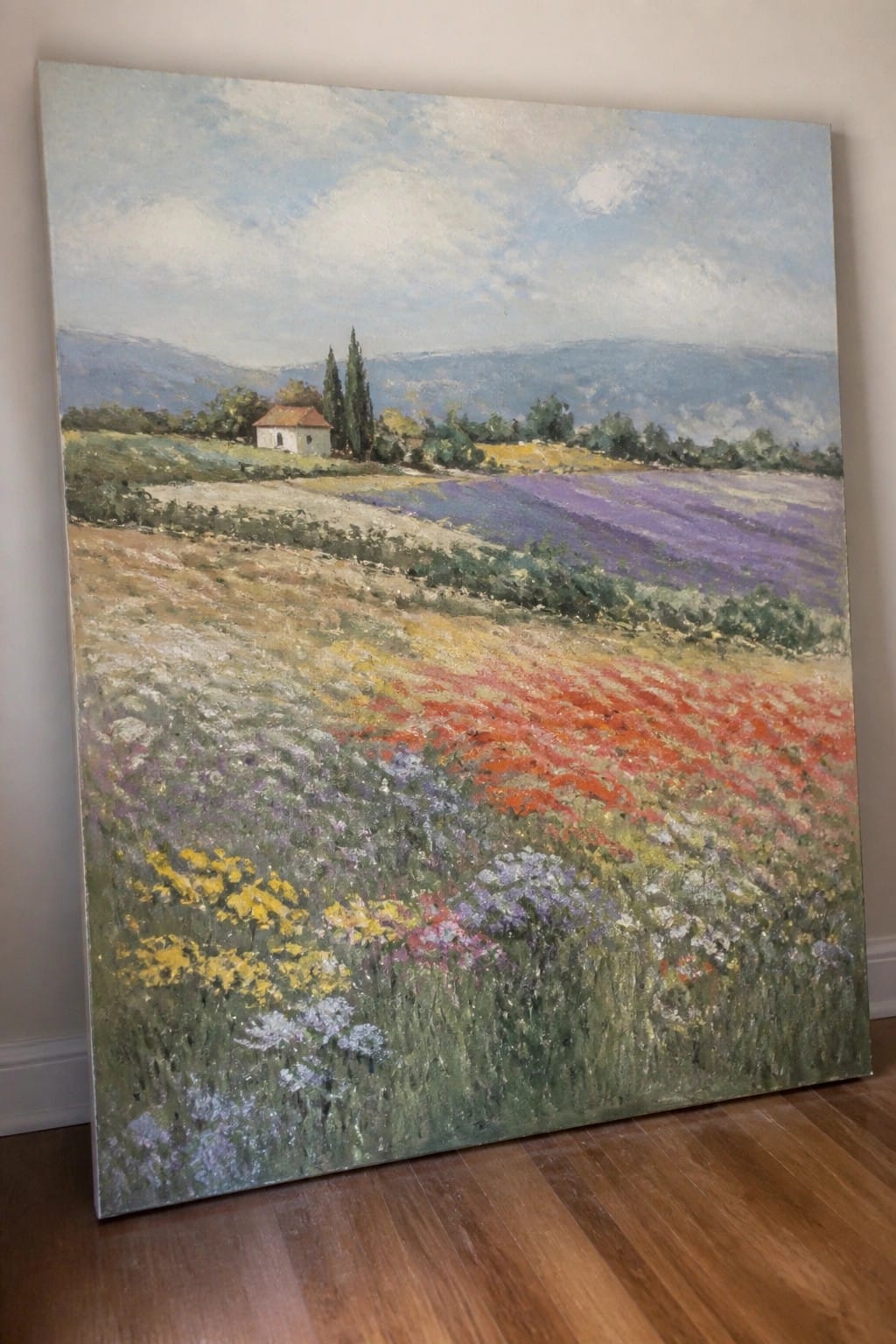 Vibrant impressionist painting of wildflower fields in red, yellow, purple with hills and house.