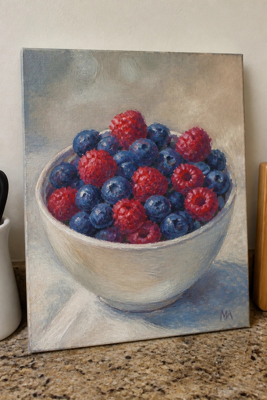 Still life painting of a white bowl brimming with blueberries and raspberries on a counter