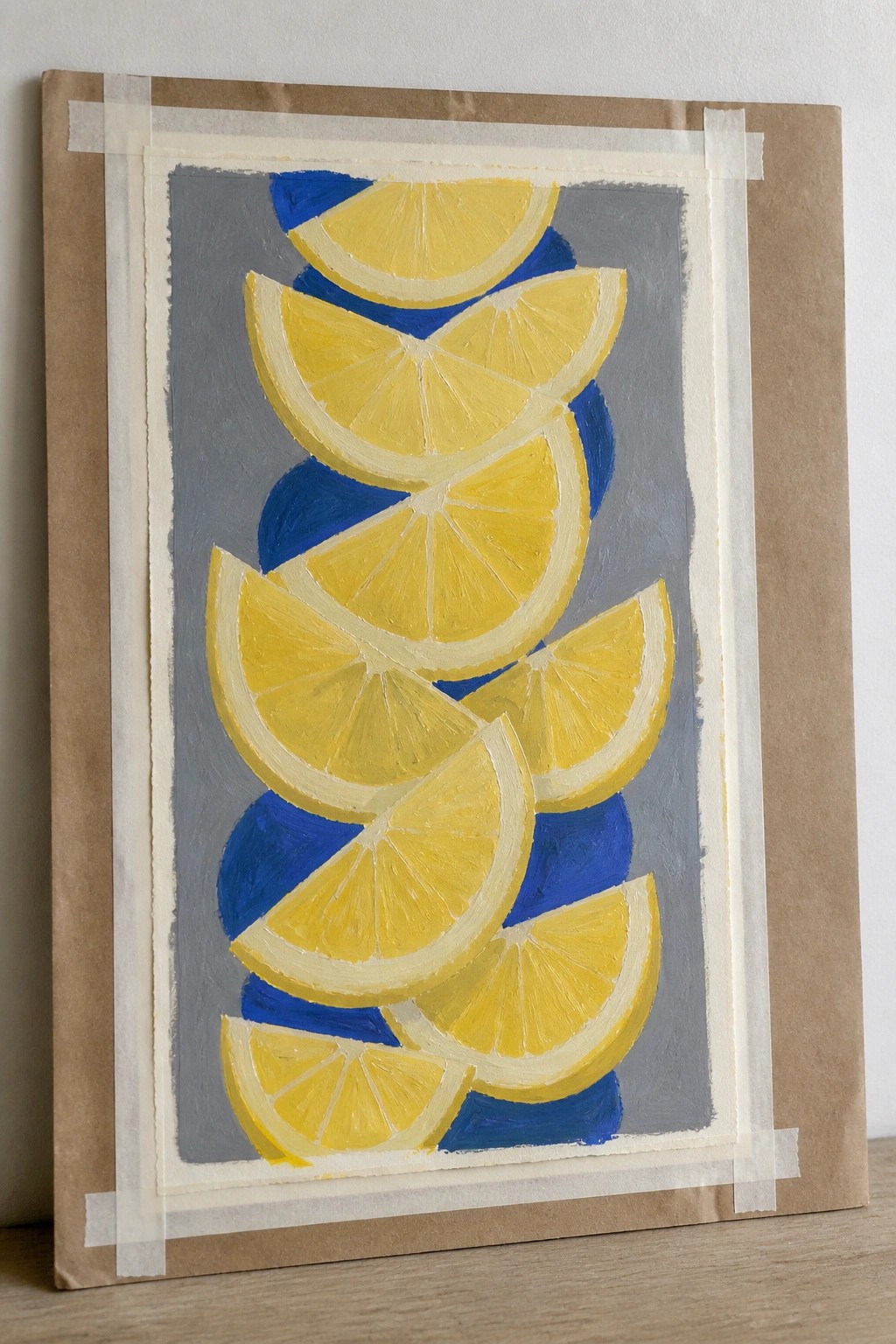 Overlapping yellow lemon slices on gray-blue background in painting taped to brown paper.