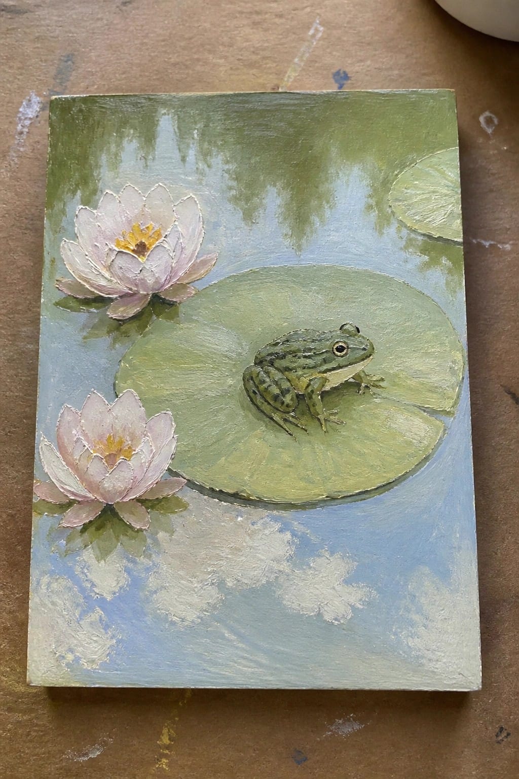 Green frog on lily pad with pink water lilies in pond painting