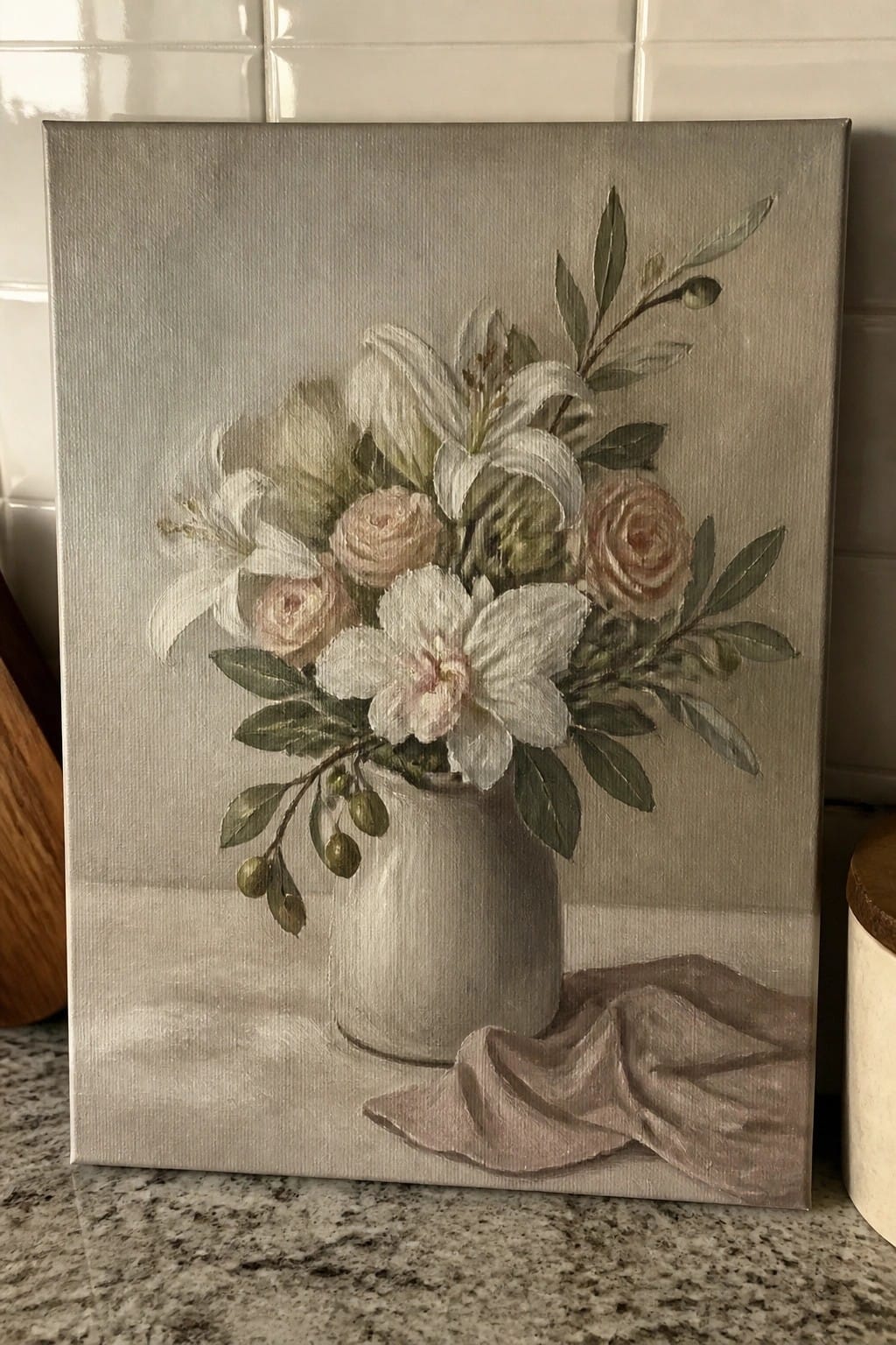 Painting of white lilies and pink roses in gray vase with draped cloth on counter