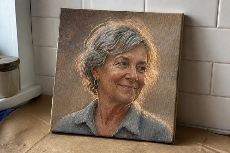 Portrait of smiling woman with light brown hair in pink collared shirt on canvas against tiles
