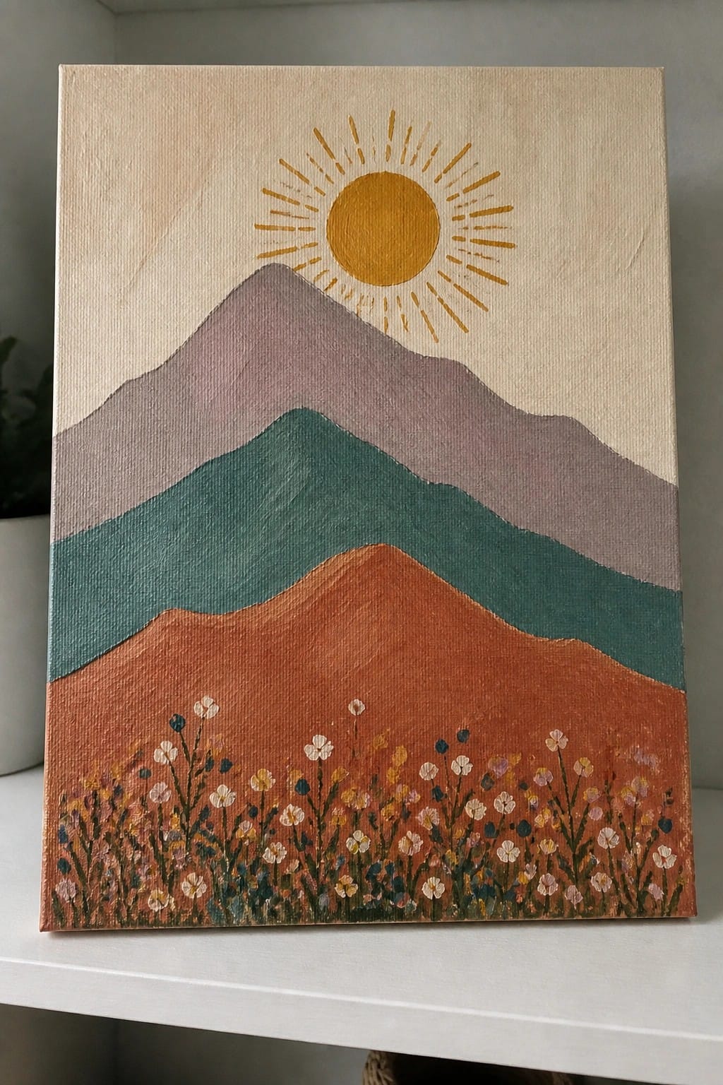 Layered mountains in purple, teal, and rust beneath a yellow sun with wildflowers.