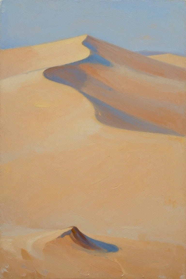 Rolling sand dunes in warm orange tones with blue shadows under clear sky