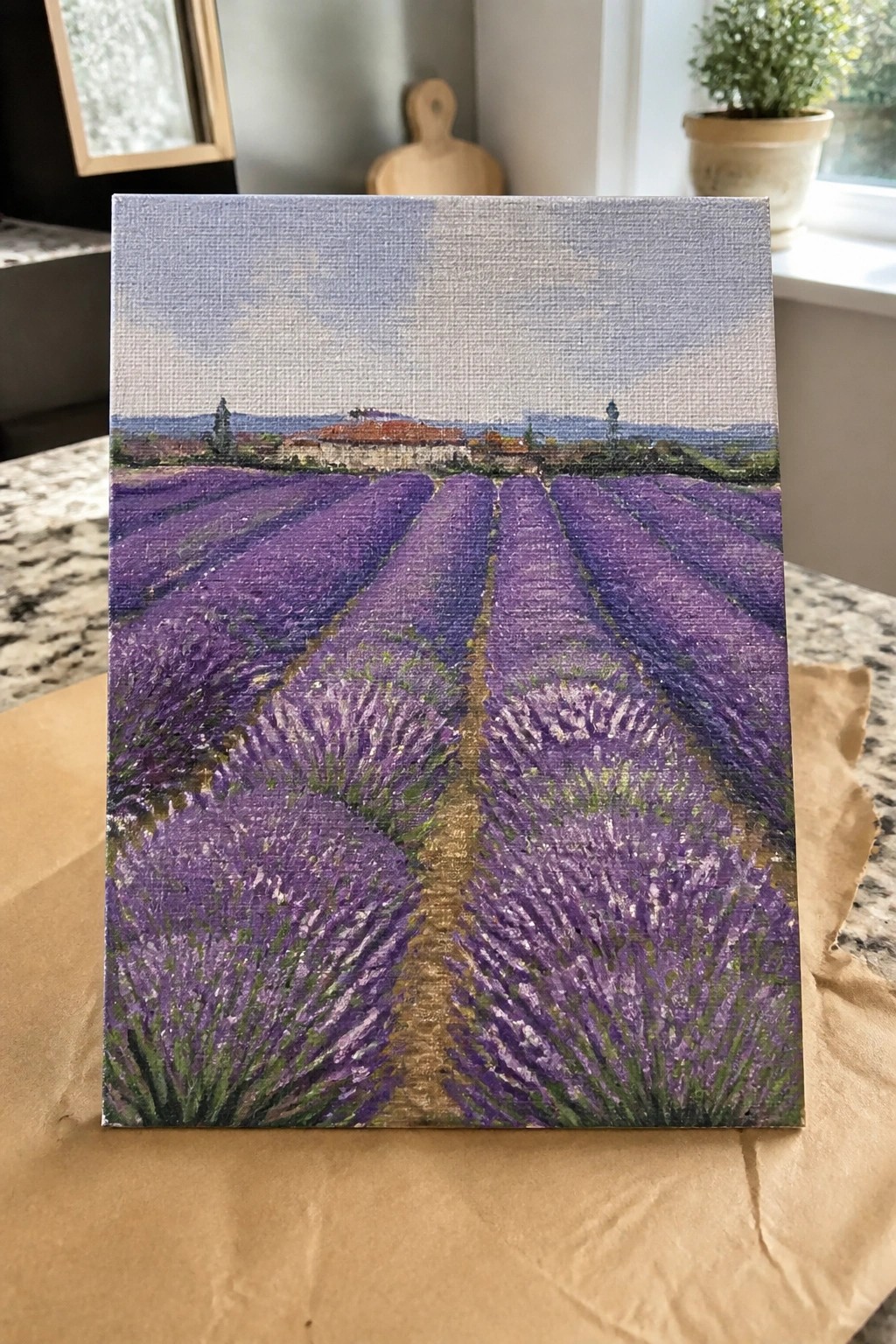 Small canvas painting of purple lavender rows leading to a distant red-roofed village.