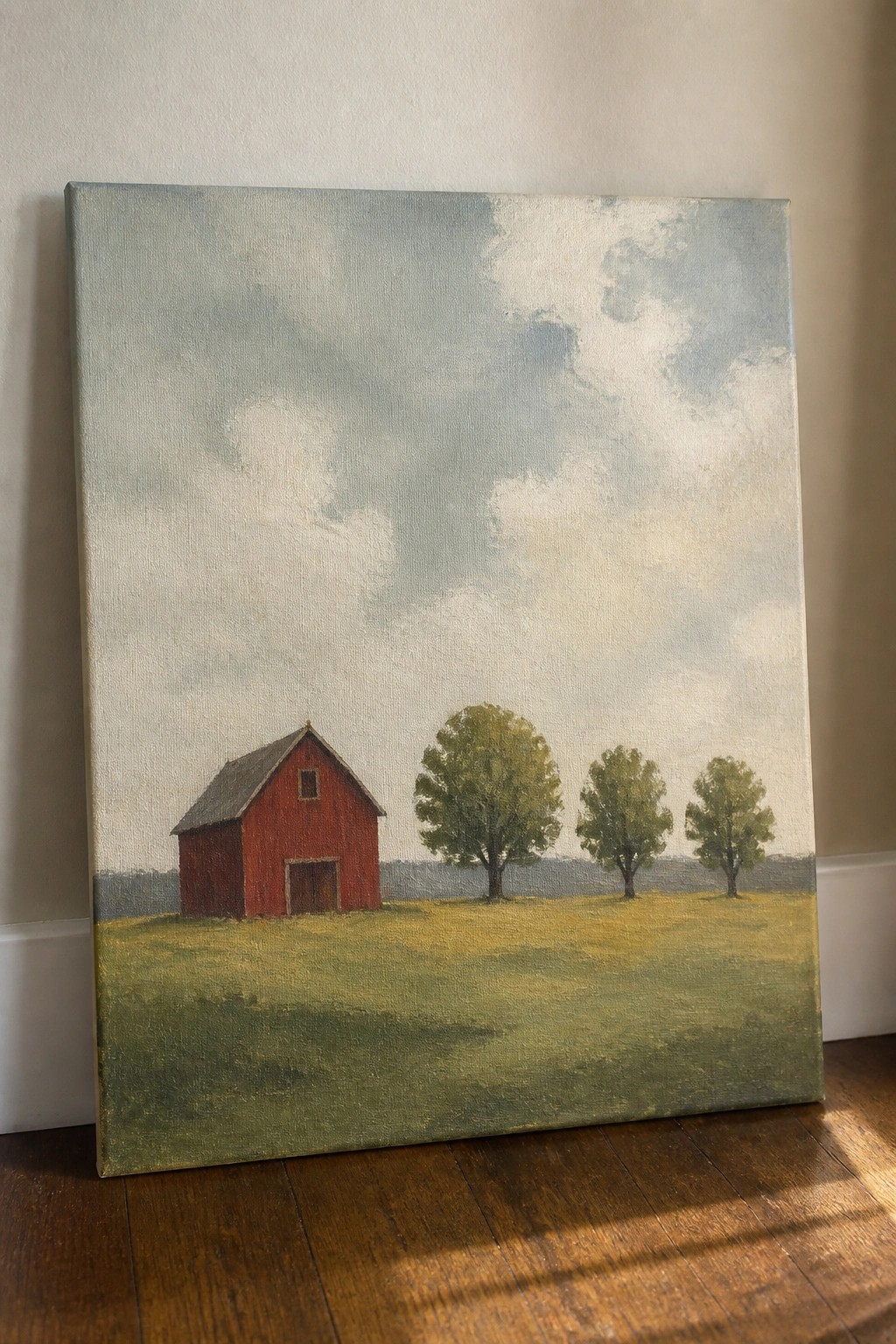 Red barn in green field with trees under cloudy sky, painting on floor