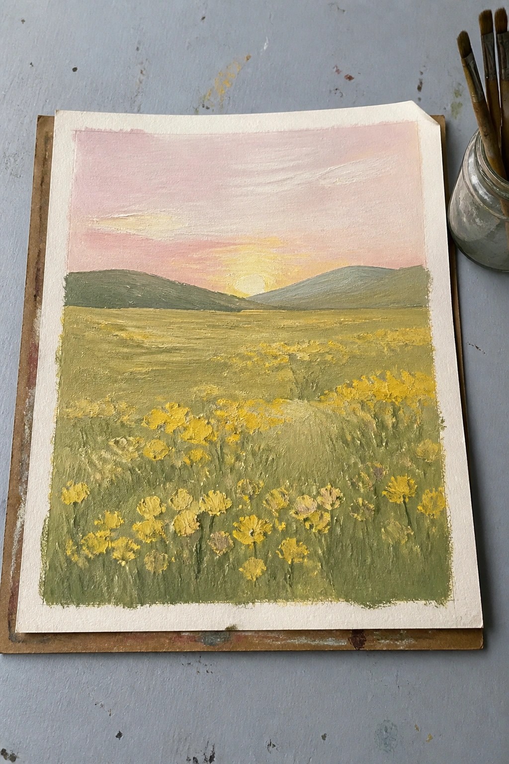 Oil painting of yellow wildflowers blooming in field at pink sunset with hills