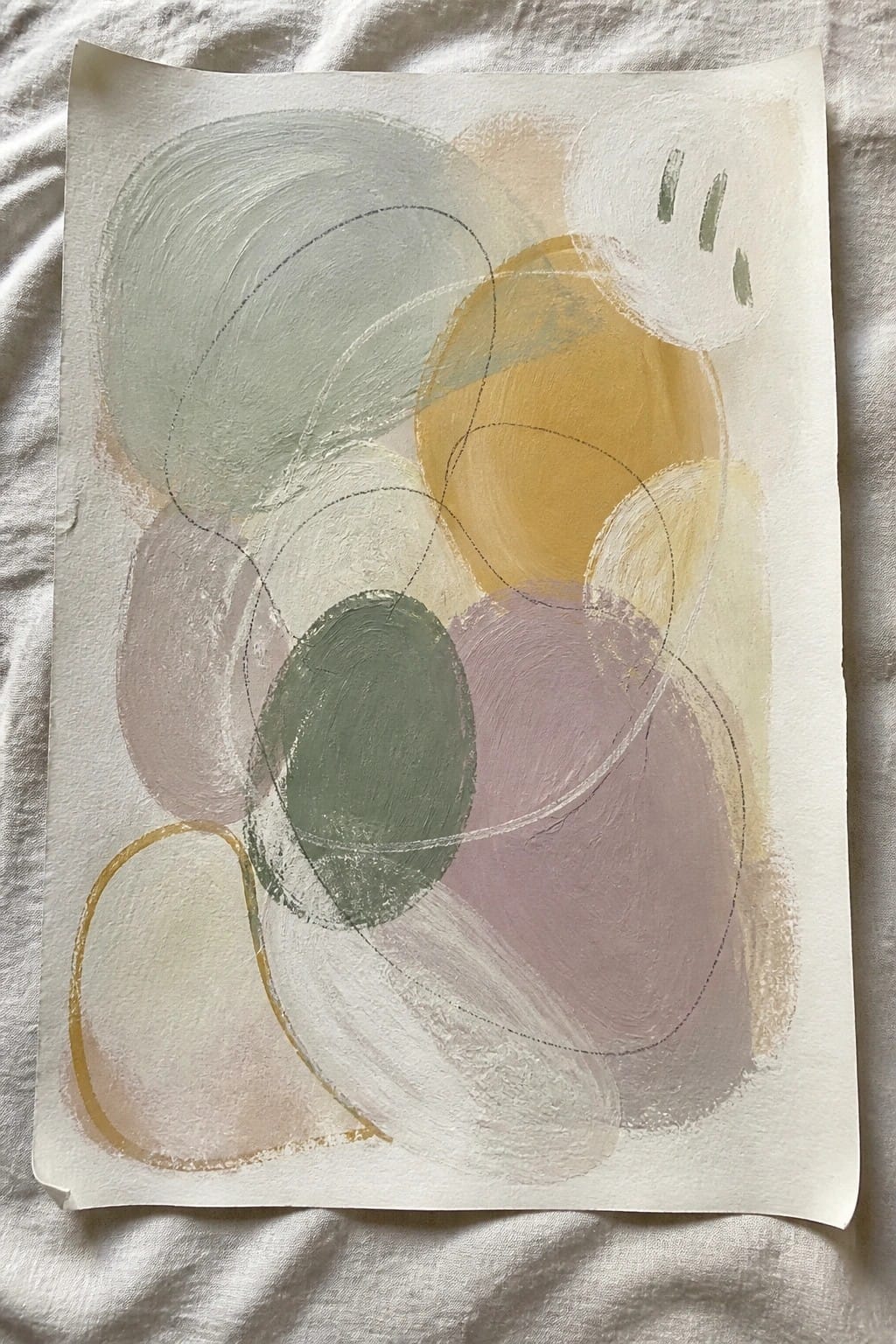 Abstract painting with overlapping pastel circles in green, yellow, and purple on paper.