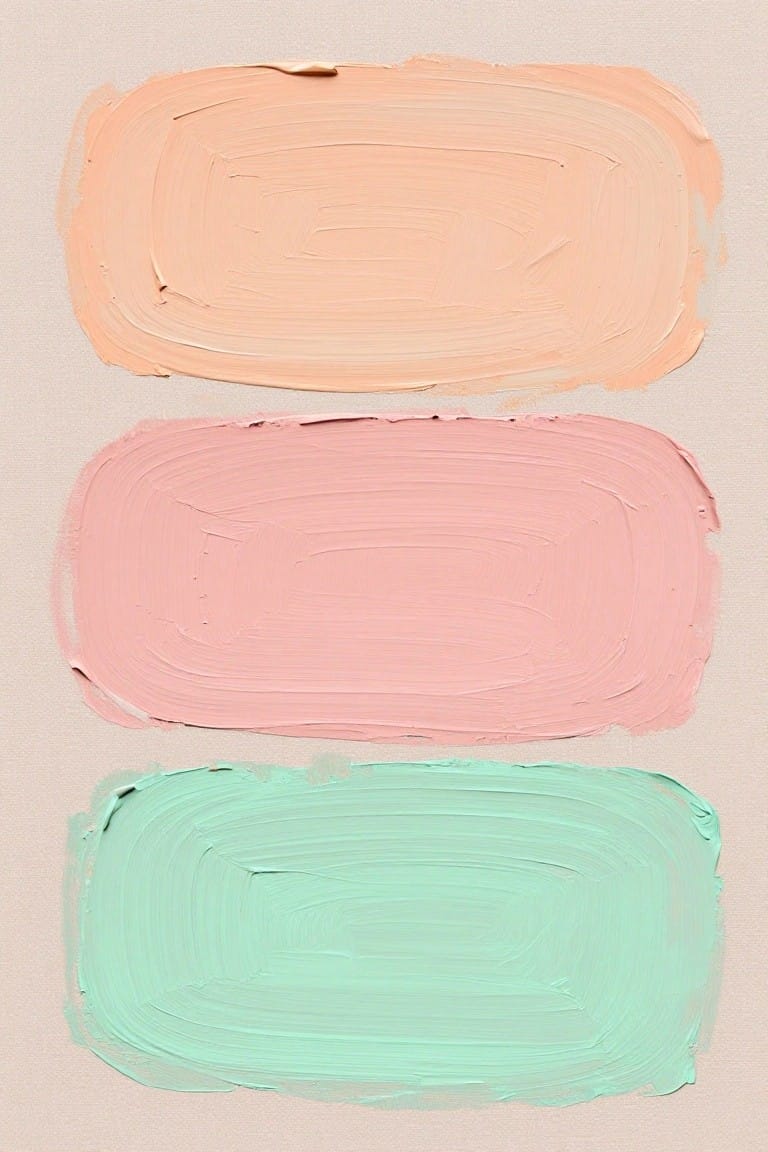 Three horizontal brushstrokes in peach, pink, and mint green paint.