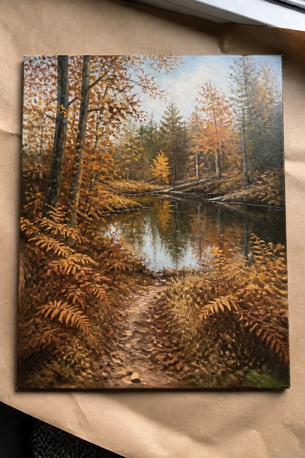 Autumn painting of winding forest path amid golden ferns beside reflective stream