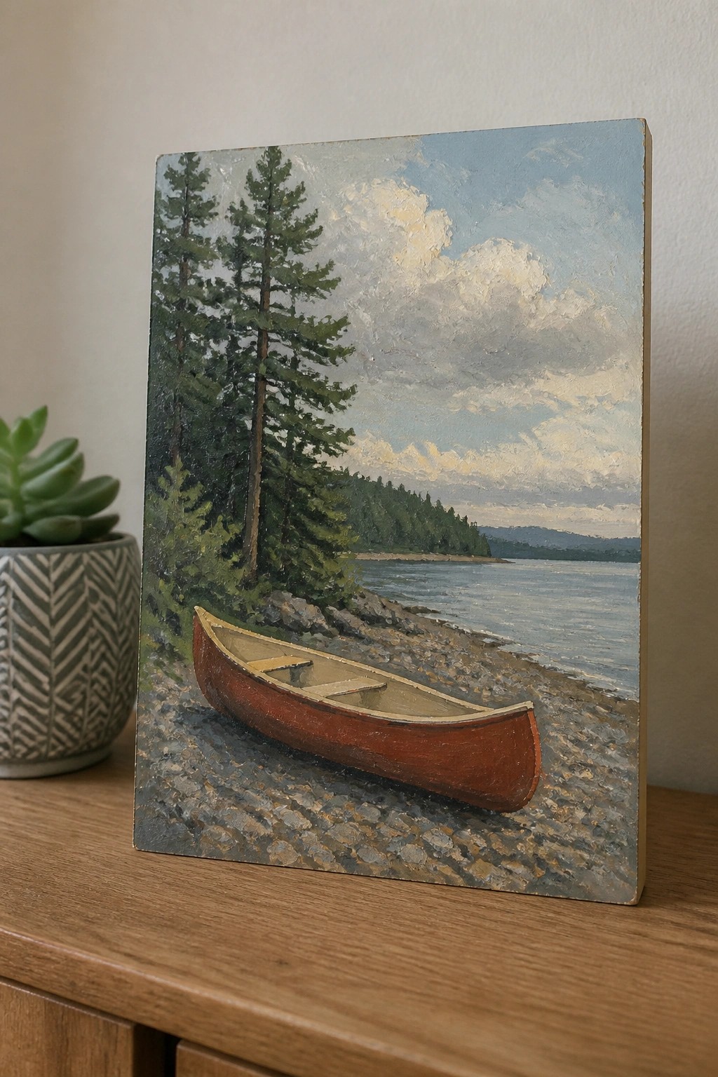 Red canoe on rocky lakeshore in landscape painting with pines and clouds