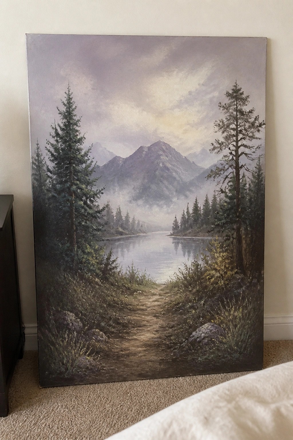 Large canvas painting of misty mountain lake with dirt path and pine trees.