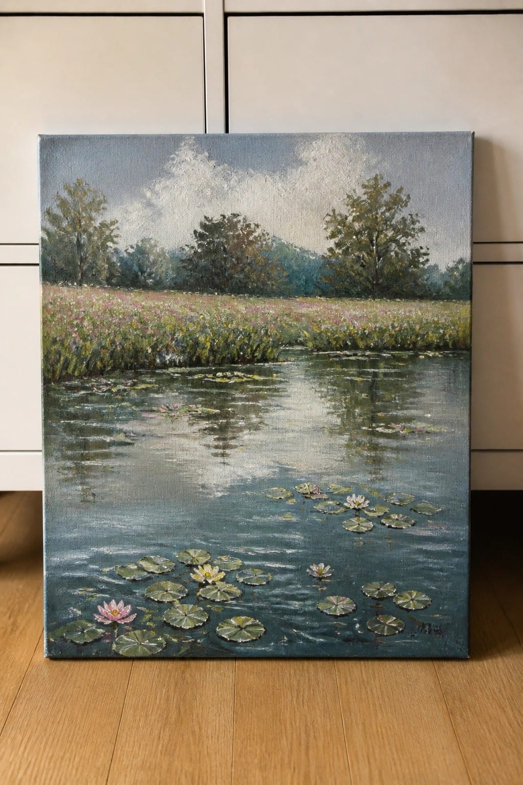Impressionistic oil painting of a pond with pink water lilies and green lily pads.