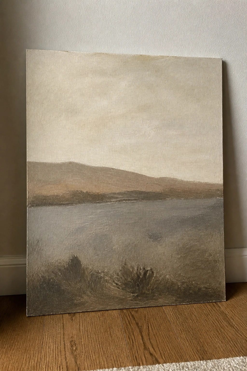 Minimalist landscape painting of calm water, distant hills, and muted sky on canvas