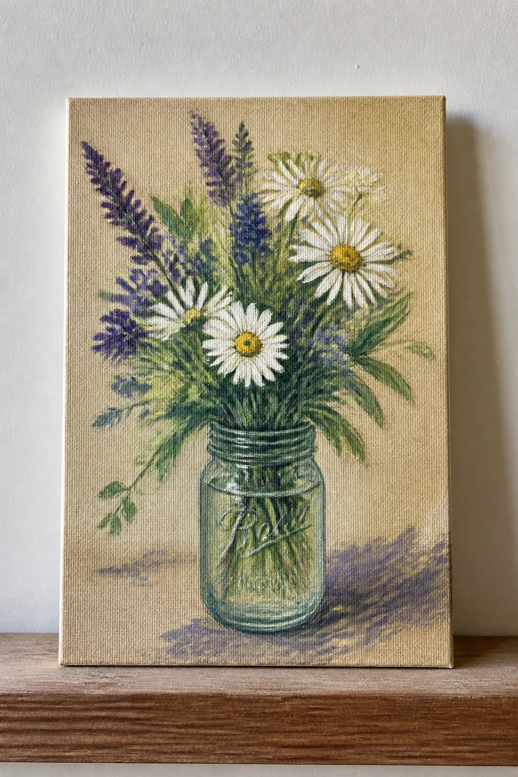 White daisies and purple flowers in a glass Ball mason jar on wood