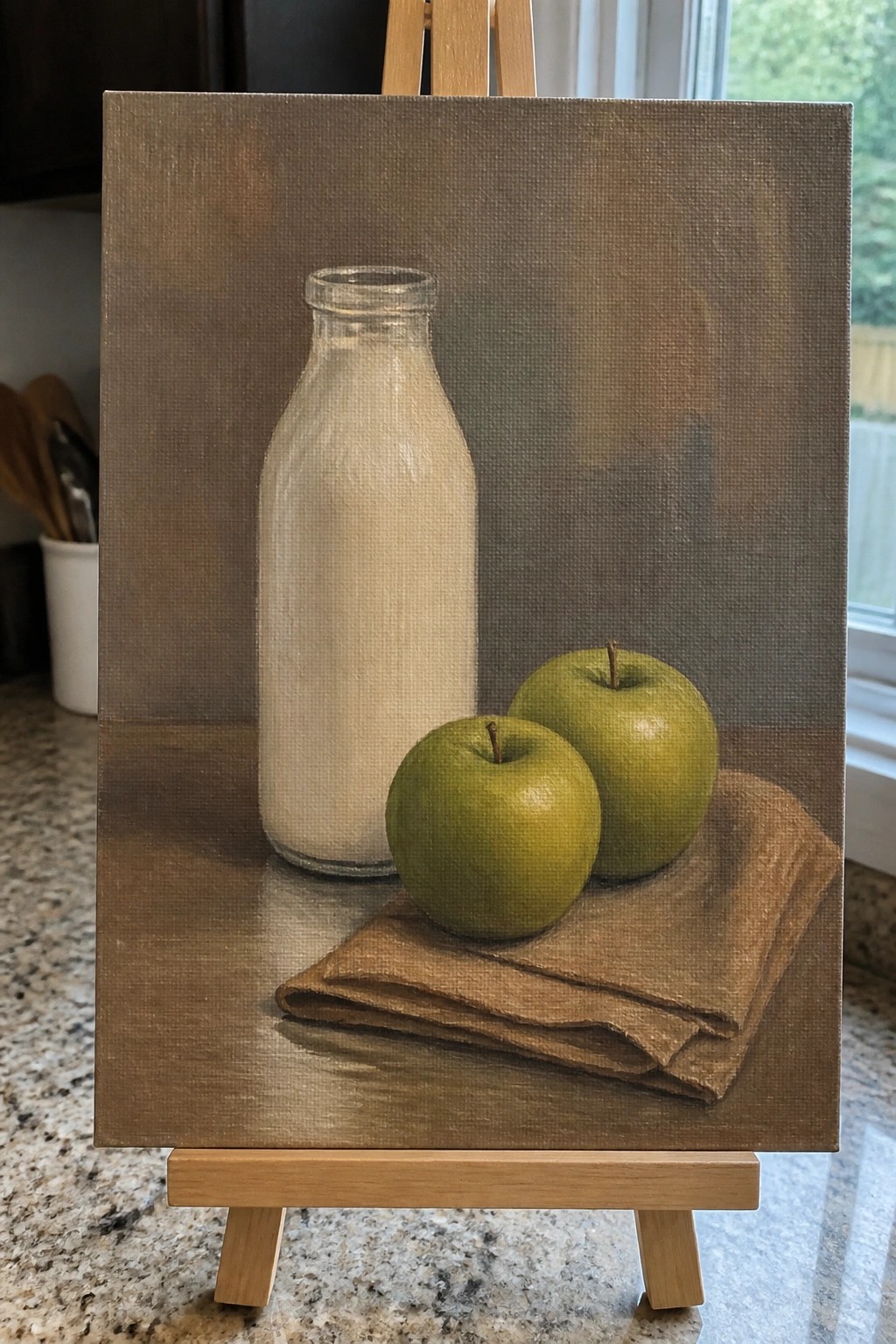 Still life painting of glass milk bottle with two green apples on brown cloth