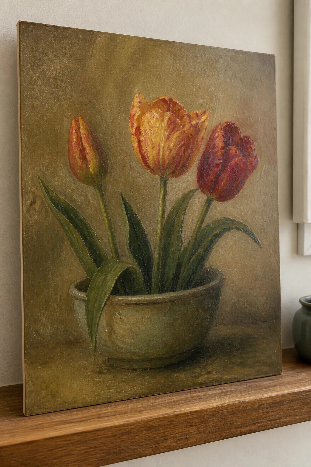 Oil painting of three red and yellow tulips in a green bowl on wood