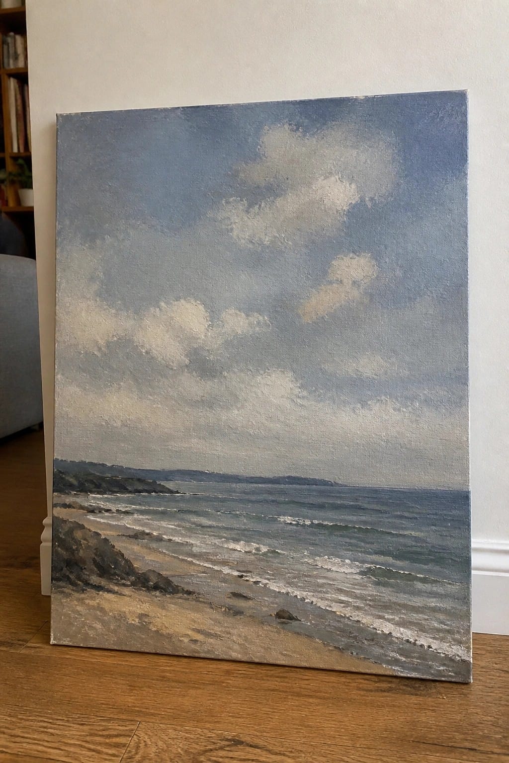 Impressionistic seascape painting of waves on a sandy beach under cloudy skies