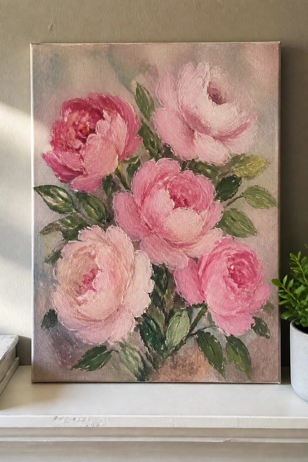 Impressionistic oil painting of blooming pink peonies with green leaves on canvas.