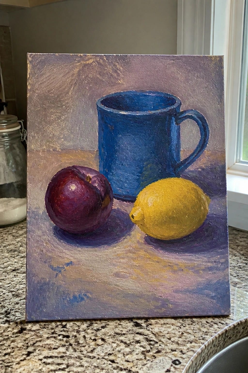 Still life painting with blue mug, dark plum, and yellow lemon on purple surface