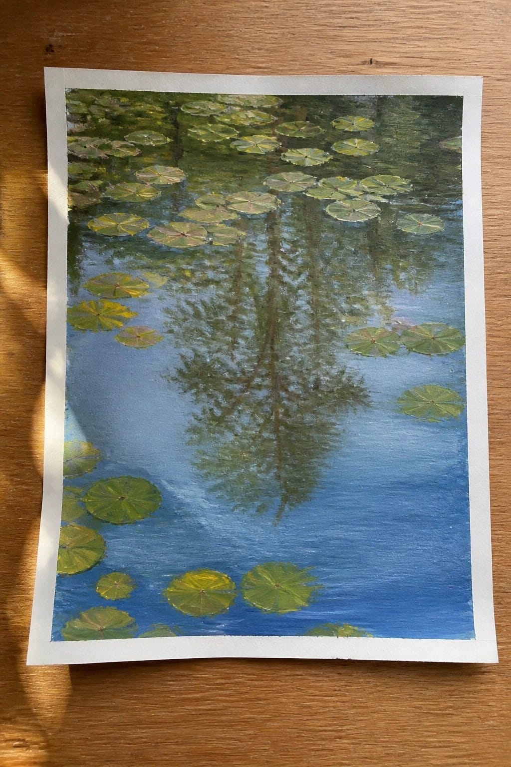 Impressionistic painting of green lily pads scattered on reflective blue pond water