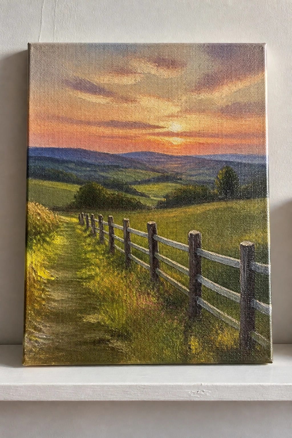 Sunset painting of rolling green hills with wooden fence along path at dusk
