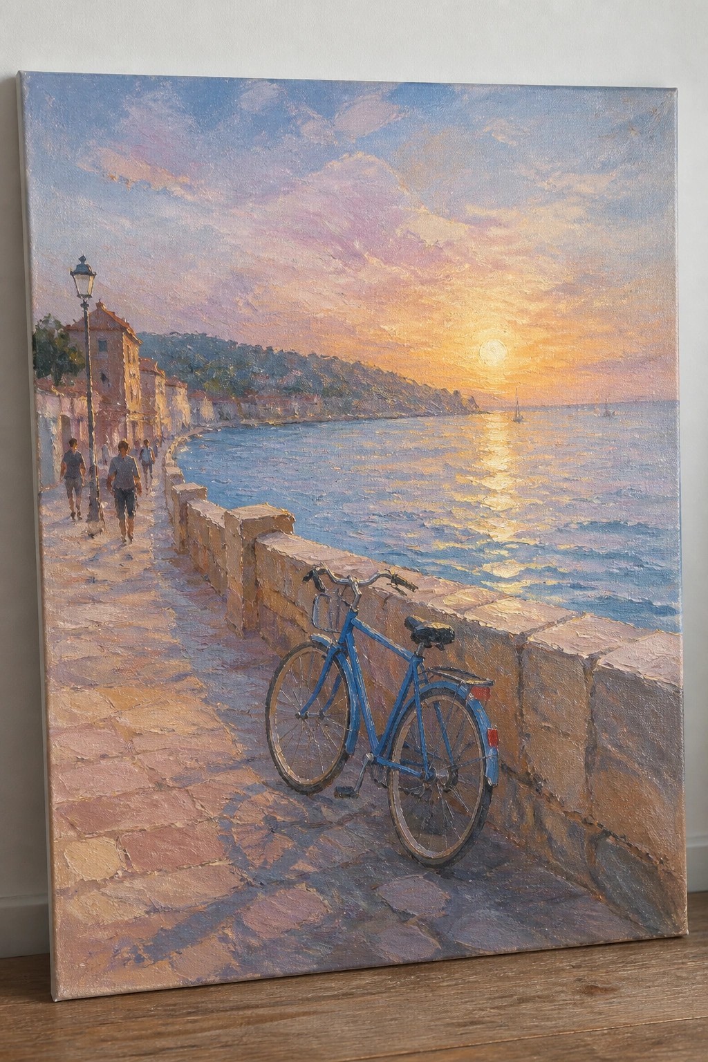 Blue bicycle parked along seaside stone wall at sunset with walkers on path