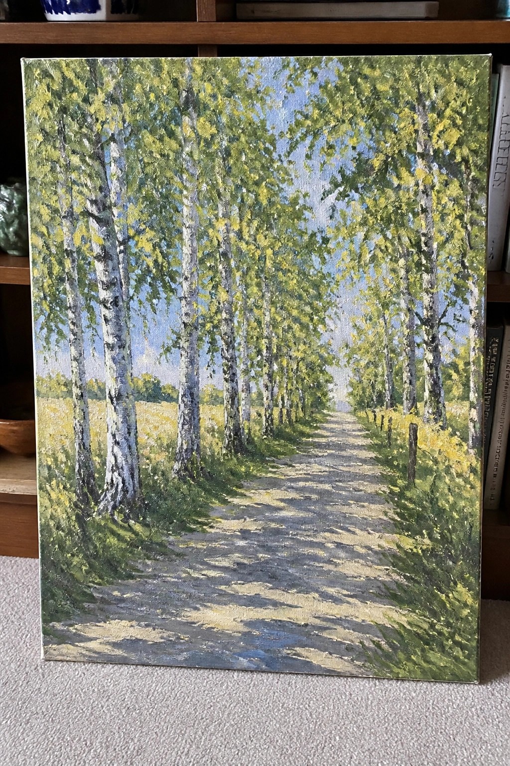 Painting of birch trees lining a sunlit dirt path with shadows and blue sky.