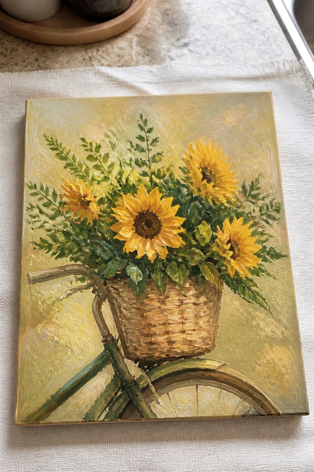 Vibrant yellow sunflowers in woven basket on green bicycle frame