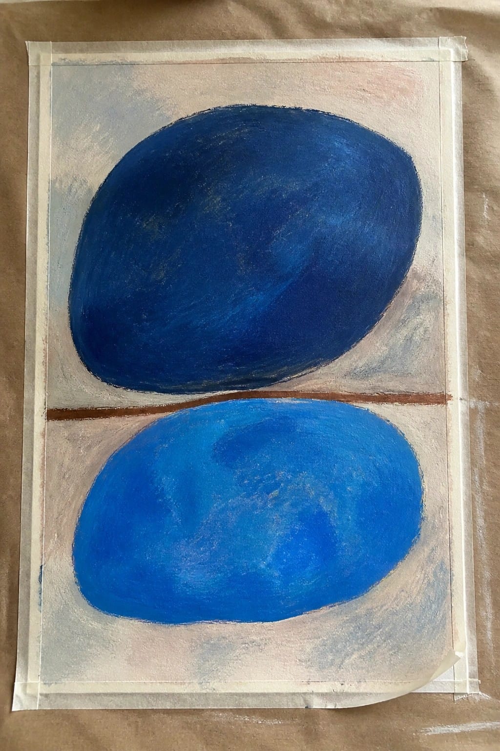 Two blue ovals on pale background separated by thin brown line, edges taped