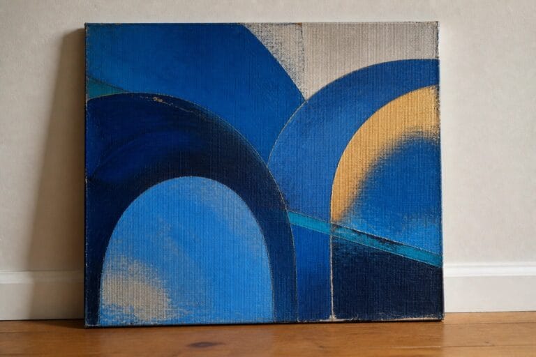 21 Bold Blue Abstract Oil Painting Ideas for Contemporary Interiors Abstract blue canvas with golden curved arc leaning on wooden floor against wall