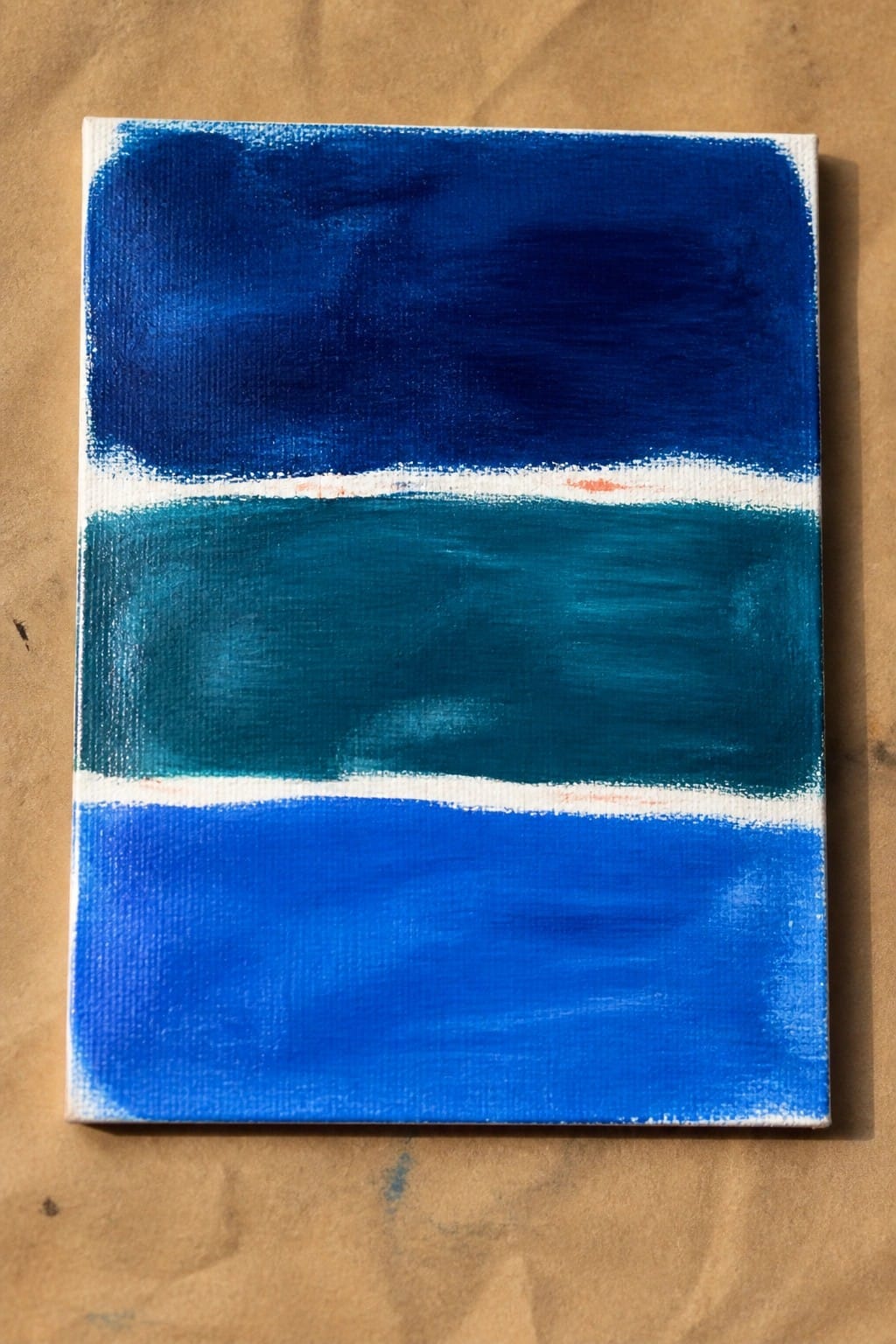Abstract canvas painting with dark blue, teal, and bright blue horizontal bands separated by white lines