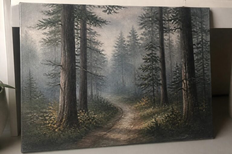 21 Cozy Forest Oil Painting Ideas for a Peaceful Moody Aesthetic Misty forest path painting on canvas leaning against white shelf on wood floor.