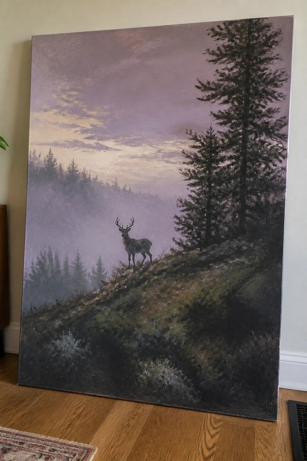 Large painting of a deer on misty hillside with pine trees and purple sky.