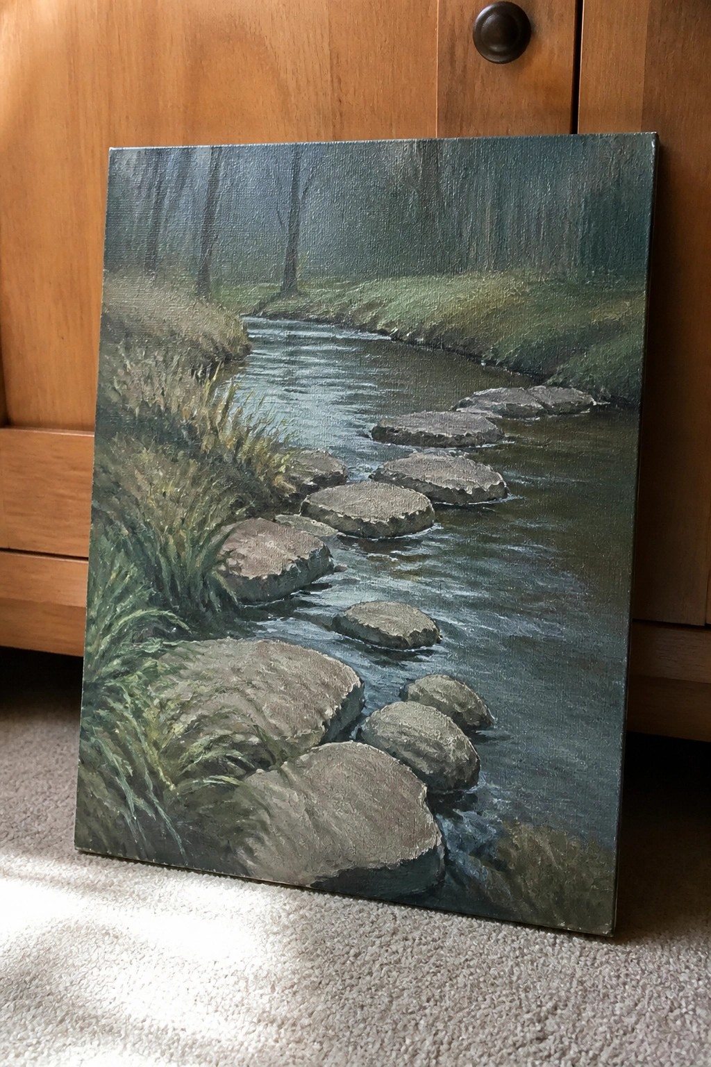 Realistic oil painting of misty forest stream with stepping stones on grassy banks