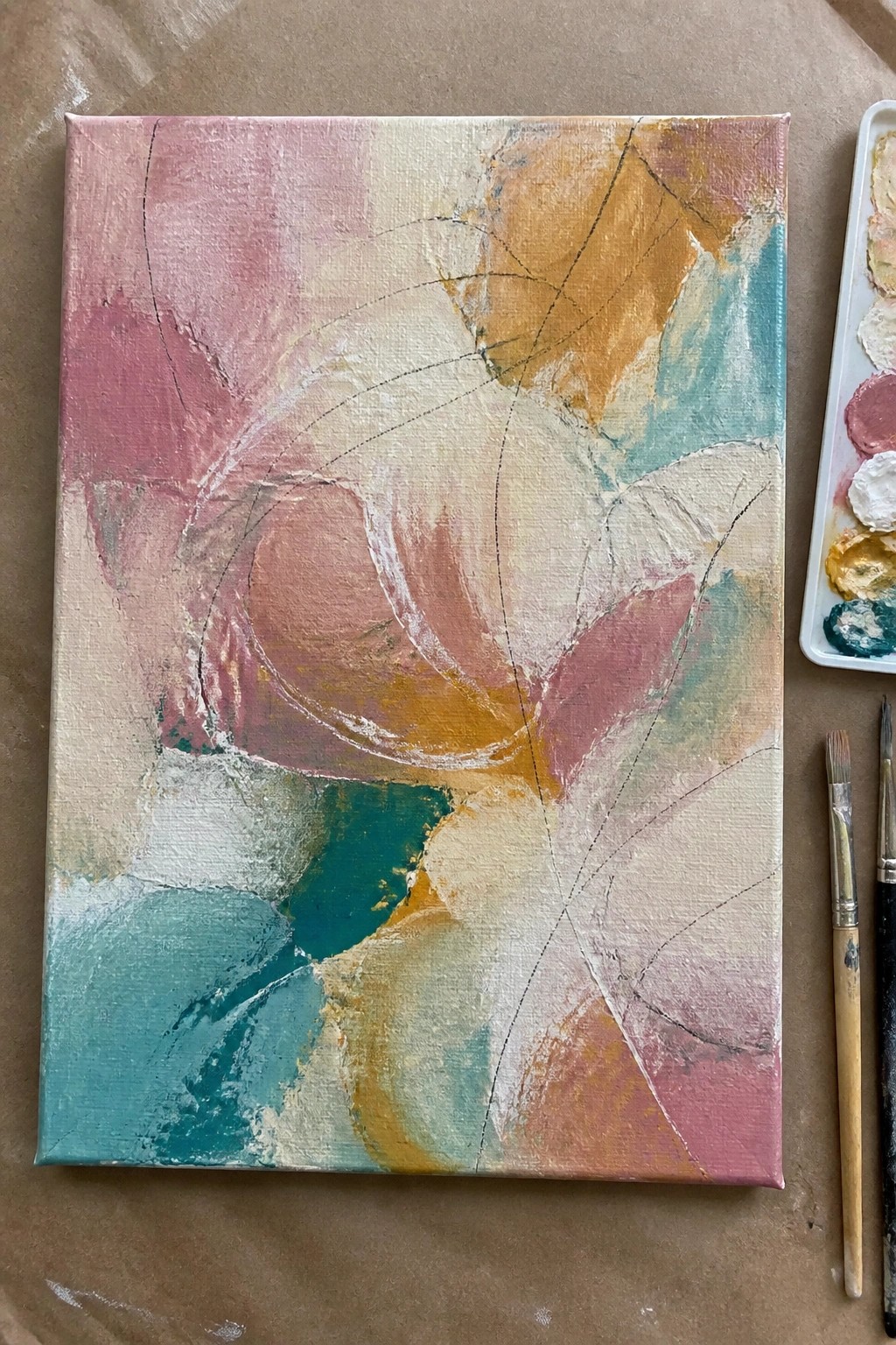 Abstract oil painting on canvas showing soft overlapping shapes in pink, orange, teal, and cream with thin black lines.