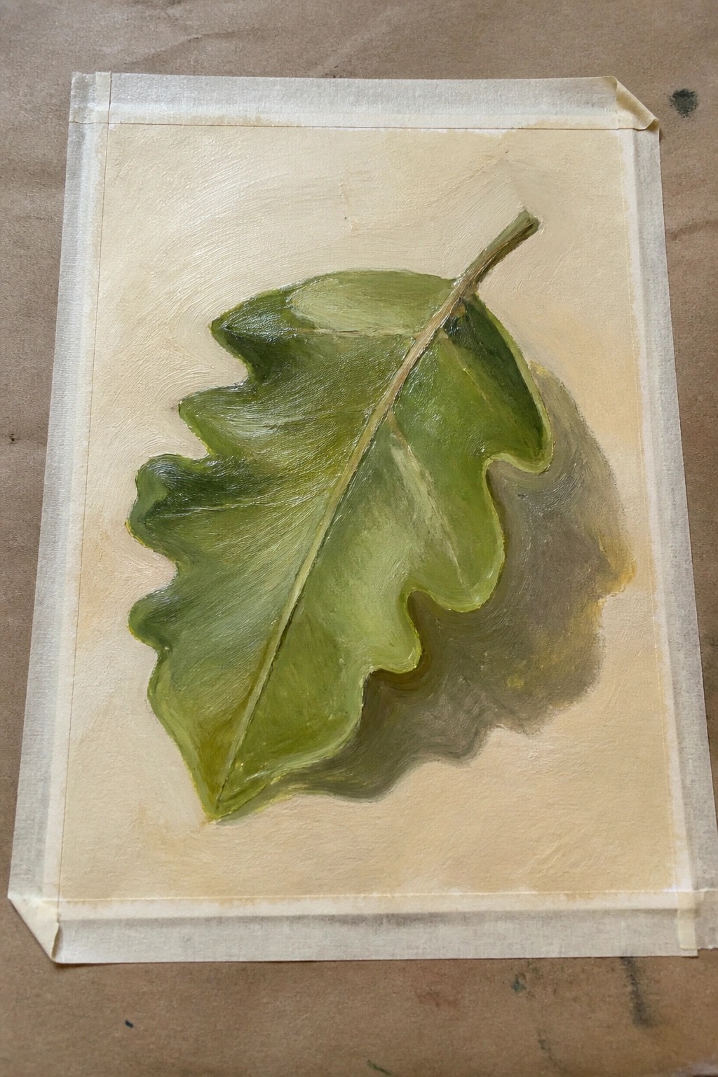 Green oak leaf painting on beige canvas with white masking tape borders