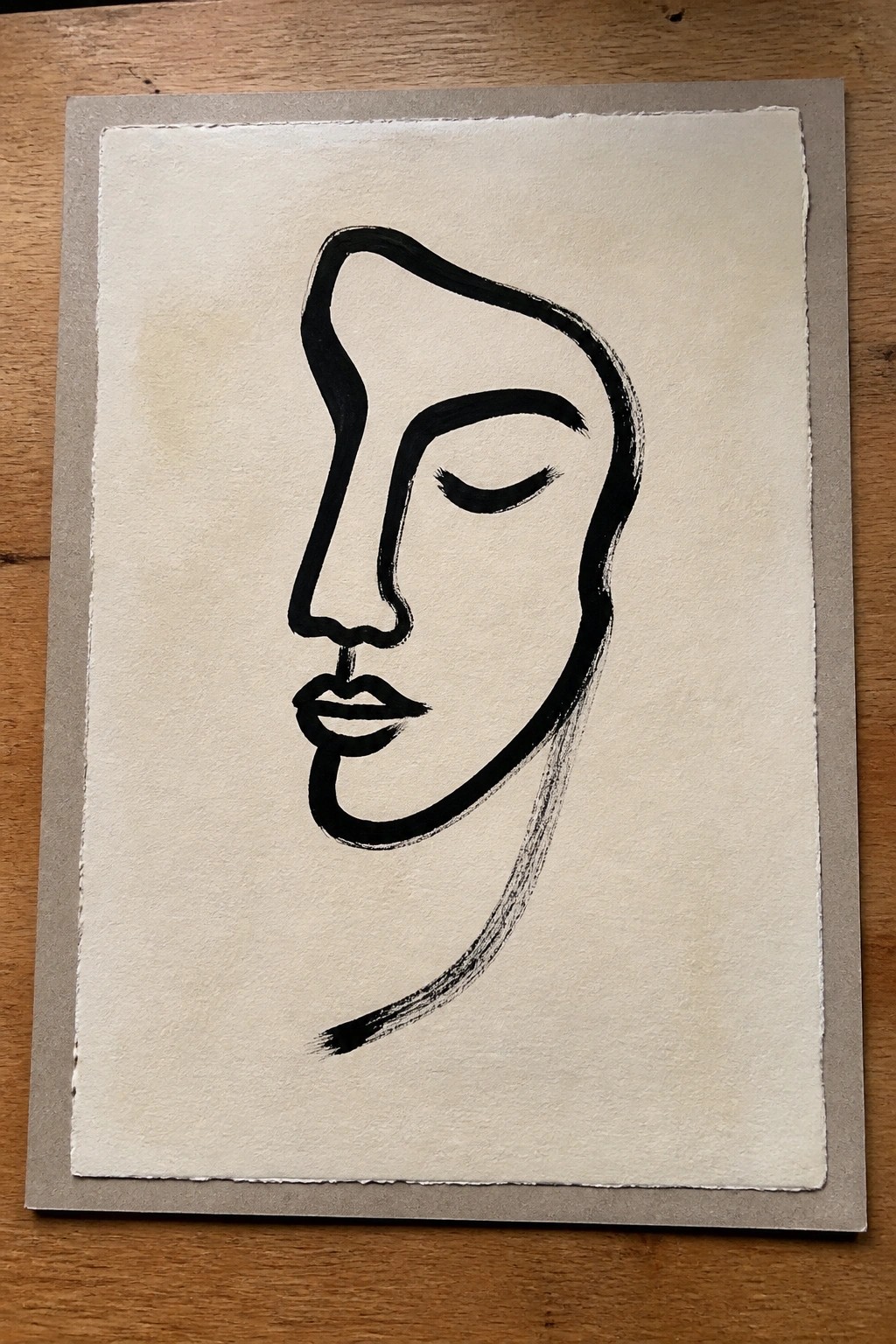 Black ink minimalist line drawing of closed-eye profile on textured paper with gray border