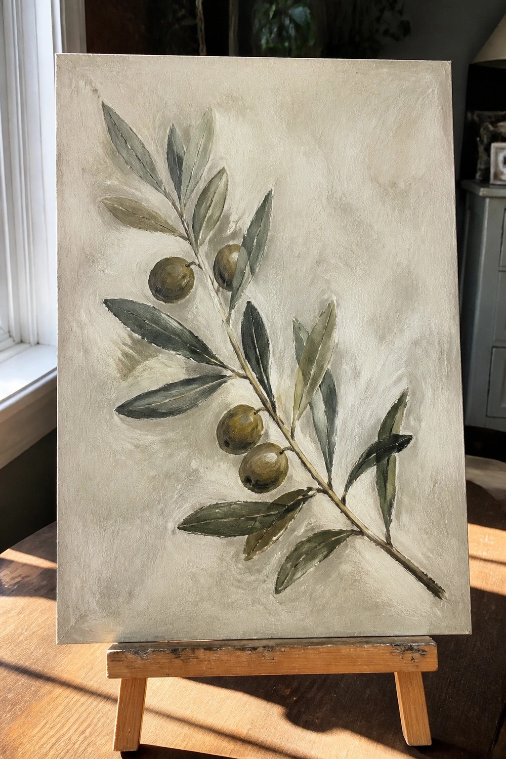 Olive branch painting with green olives and leaves on canvas easel