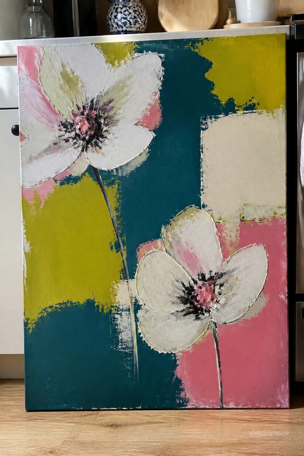 Abstract painting of two white flowers with pink centers on teal, yellow, and pink background