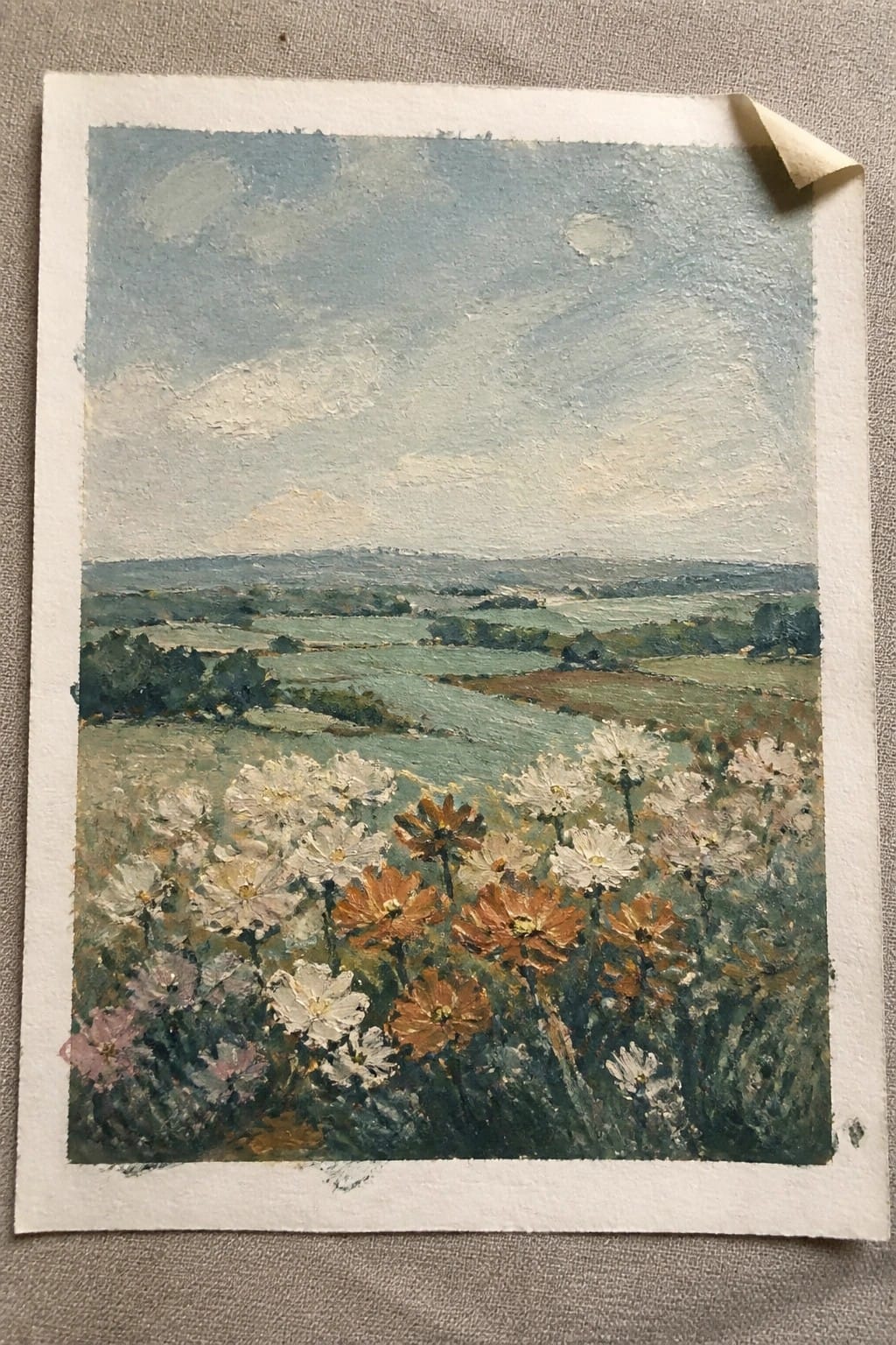 Impressionistic painting of white, orange, and pink wildflowers overlooking rolling green hills and valleys.
